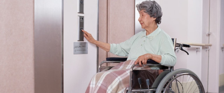 Woman in Nursing Home Waiting for Elevator